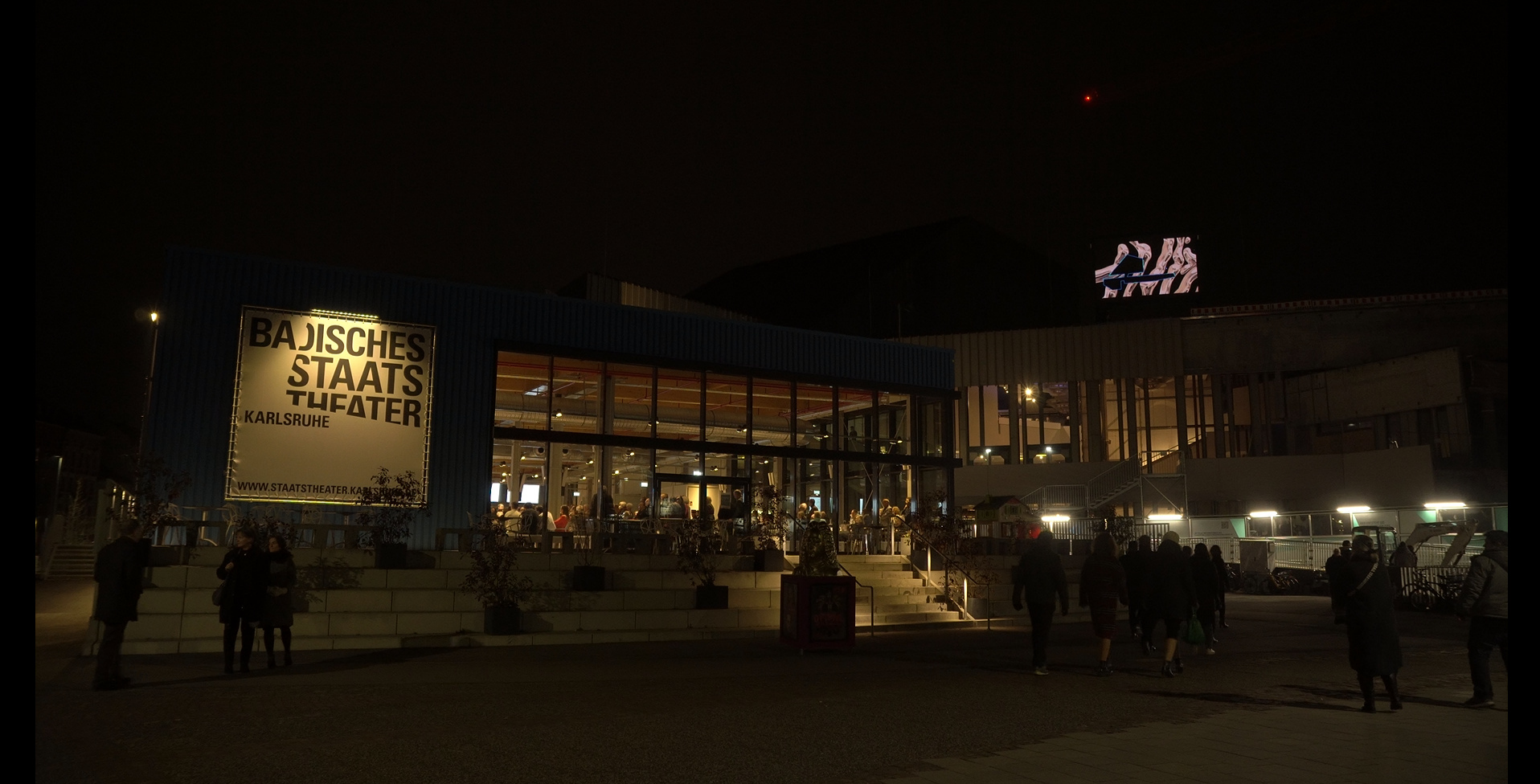 area photo of the theatre and the square in front of it at night